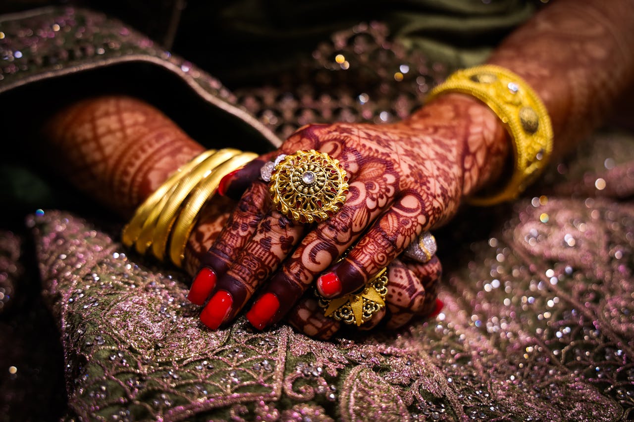 Close-up of beautifully hennaed hands with ornate jewelry, showcasing traditional culture in Srinagar.